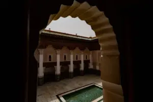 Courtyard with ornate arches and a pool.