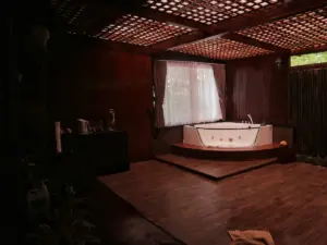 Luxurious corner jacuzzi tub with wooden accents and natural light.